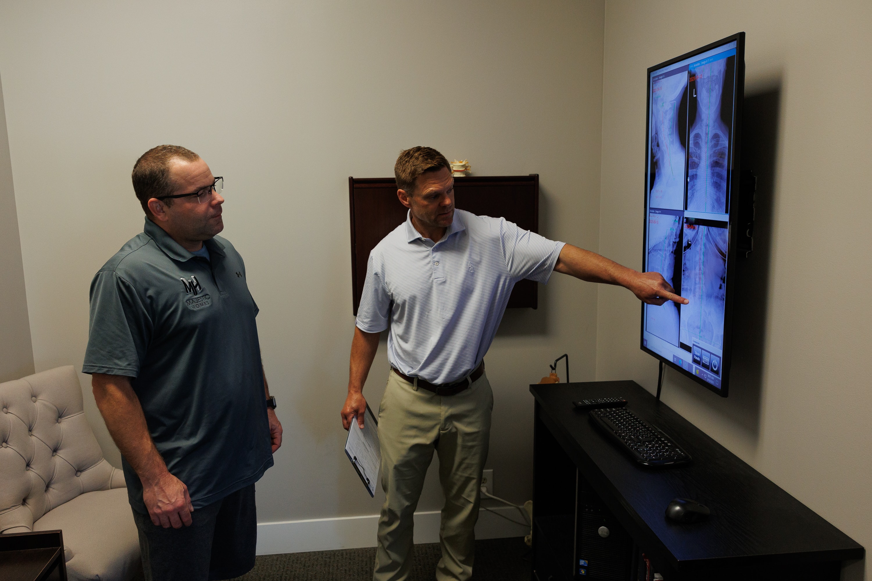 Doctor reviewing a patient's cervical spine X-ray as part of a neck and migraine evaluation